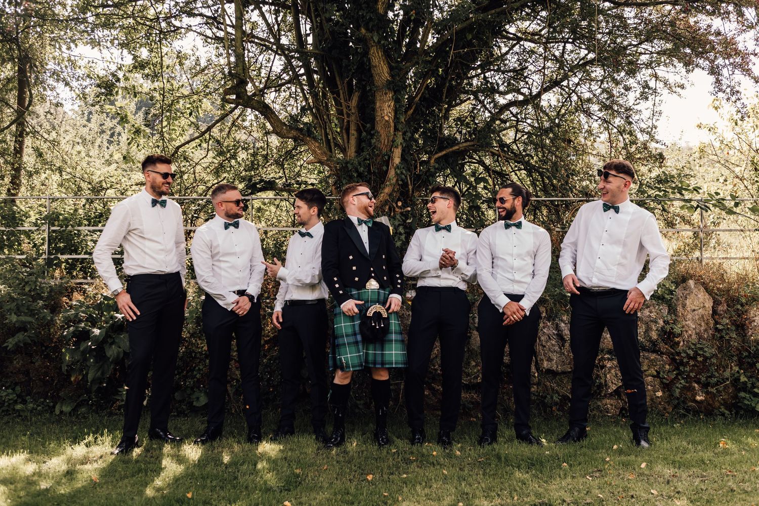 groom with groomsmen laughing