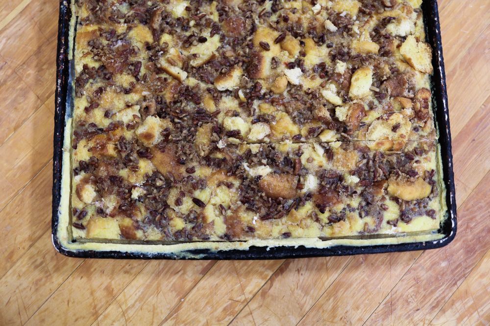Close up of baked dessert with crumb topping in metal baking pan.