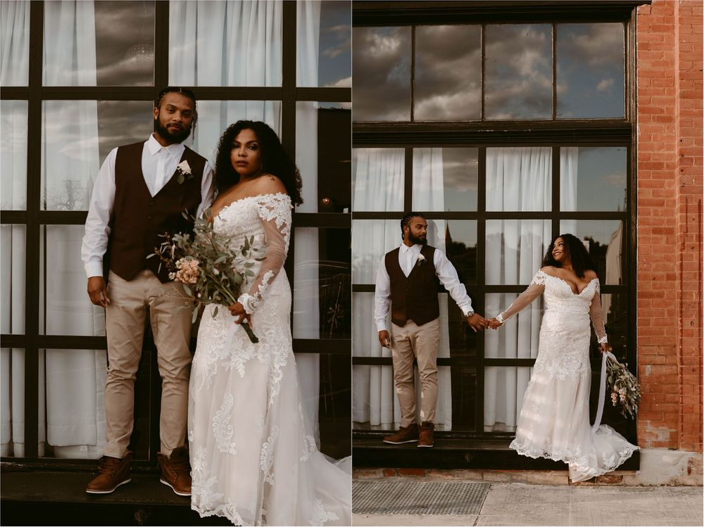 Elegant wedding couple poses for photos against an industrial brick building with windows.