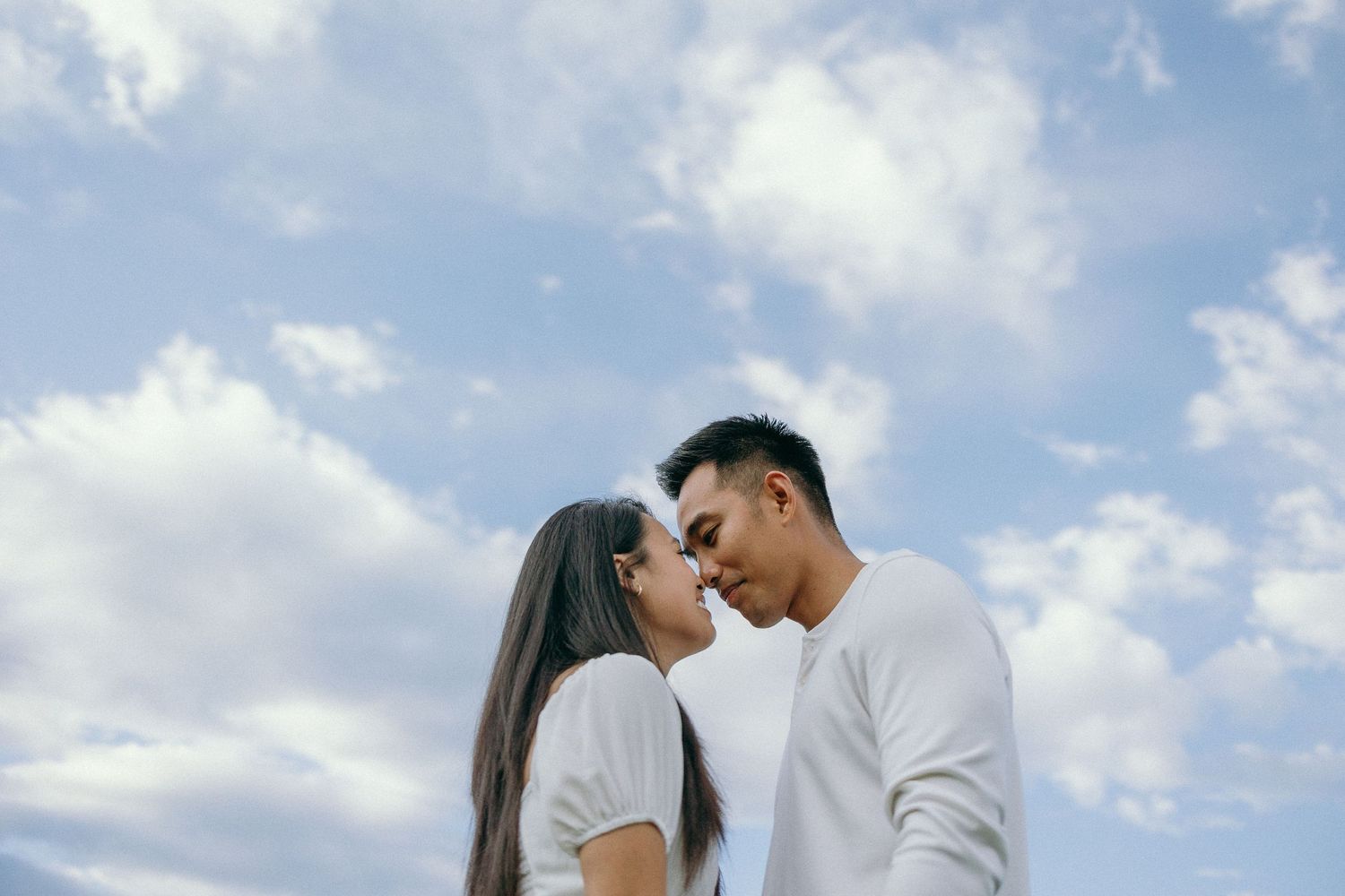Romantic couple photos against blue sky and white clouds background.
