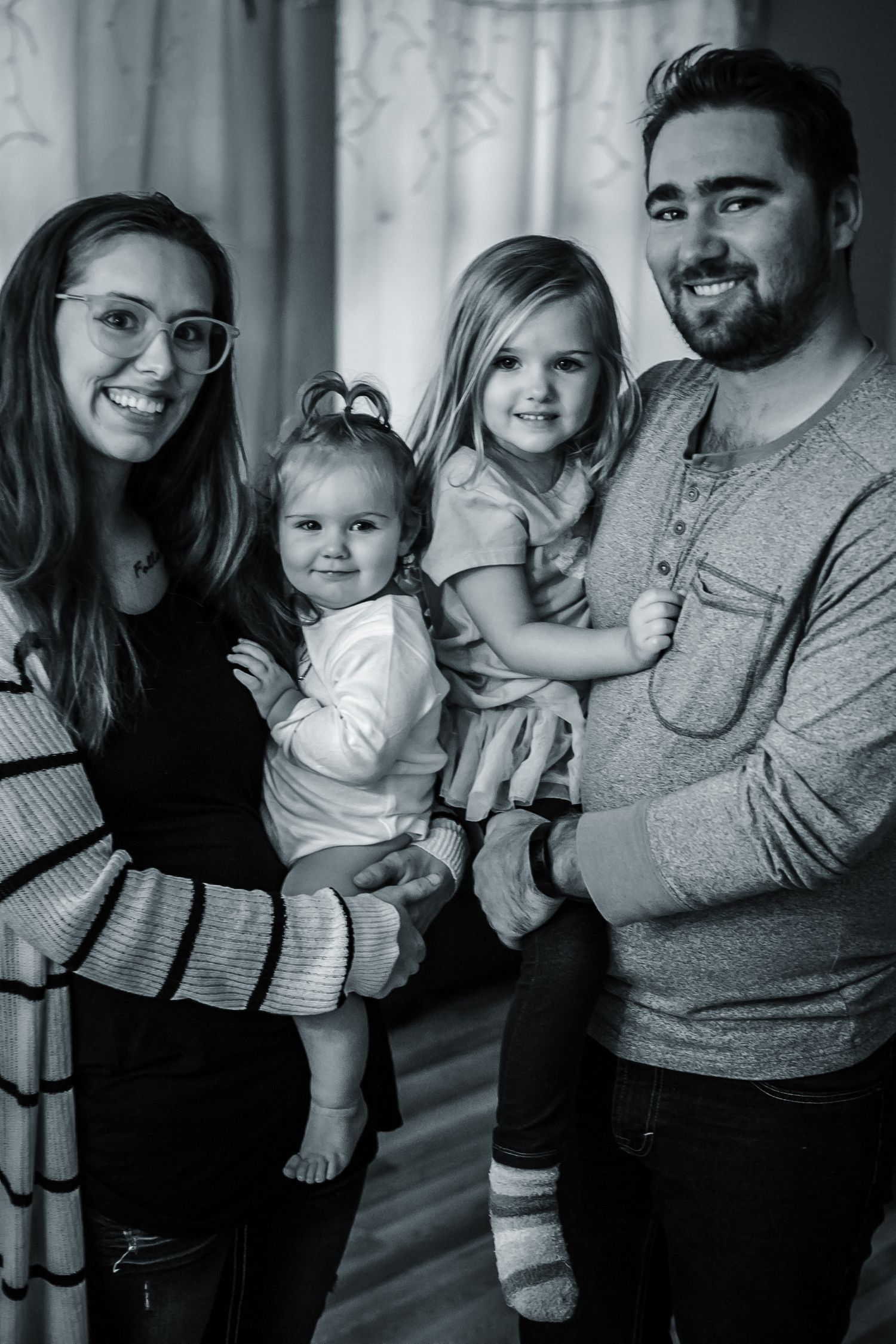 Mom and dad holding their girls for a great family photo in Sioux City, Ia. beautiful family