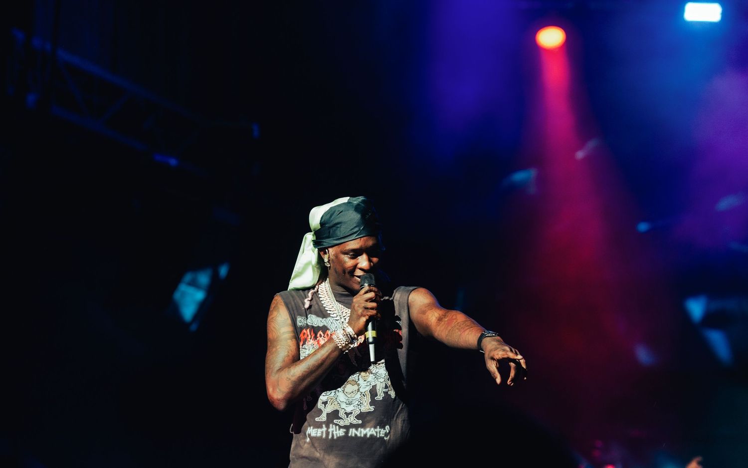 Hip-hop artist engaging with crowd at concert, young thug