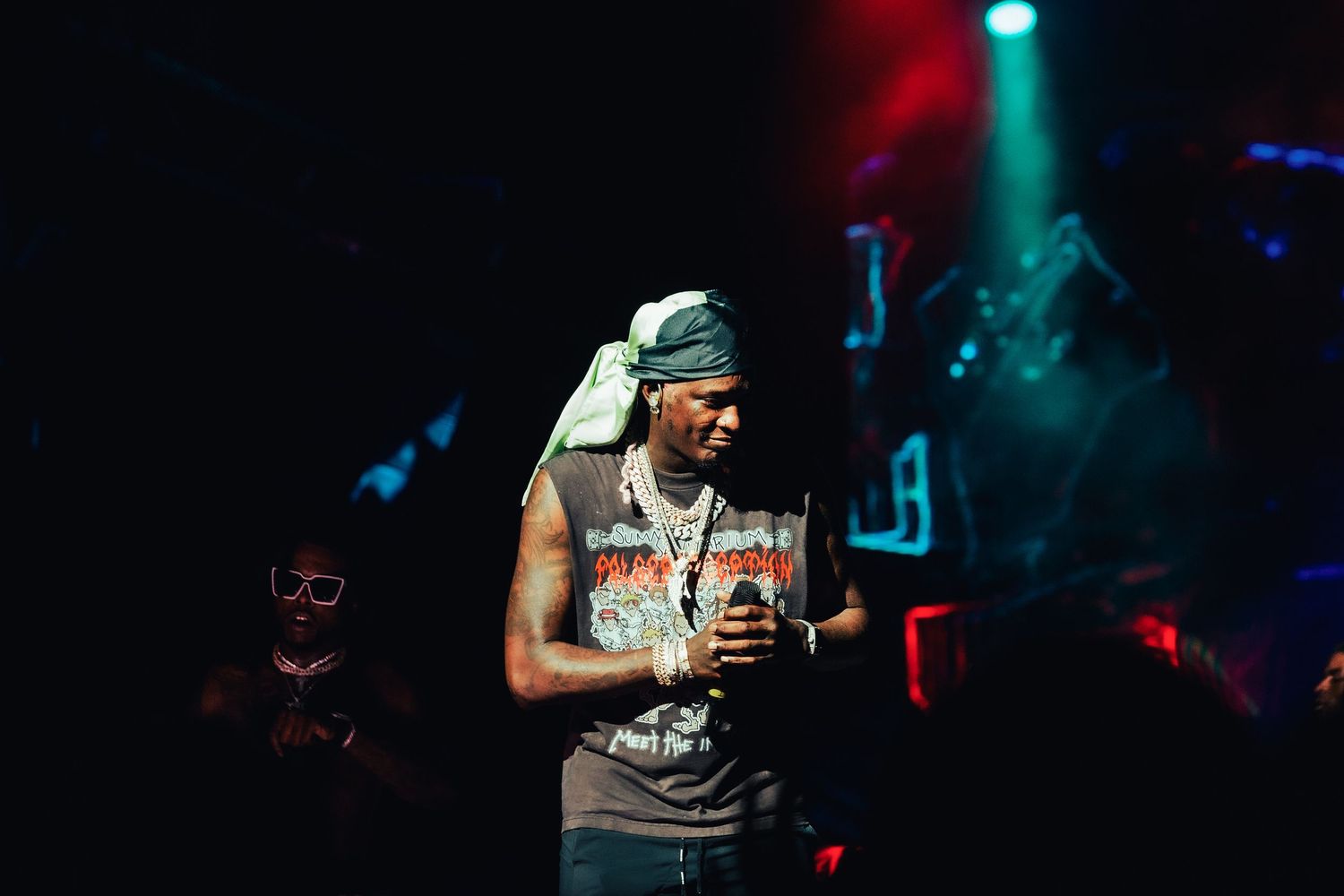 Rapper holding microphone during live show, young thug