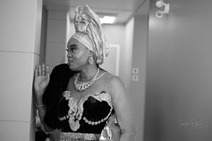 Black and white portrait showing traditional Nigerian attire with elaborate headwrap and jewelry.