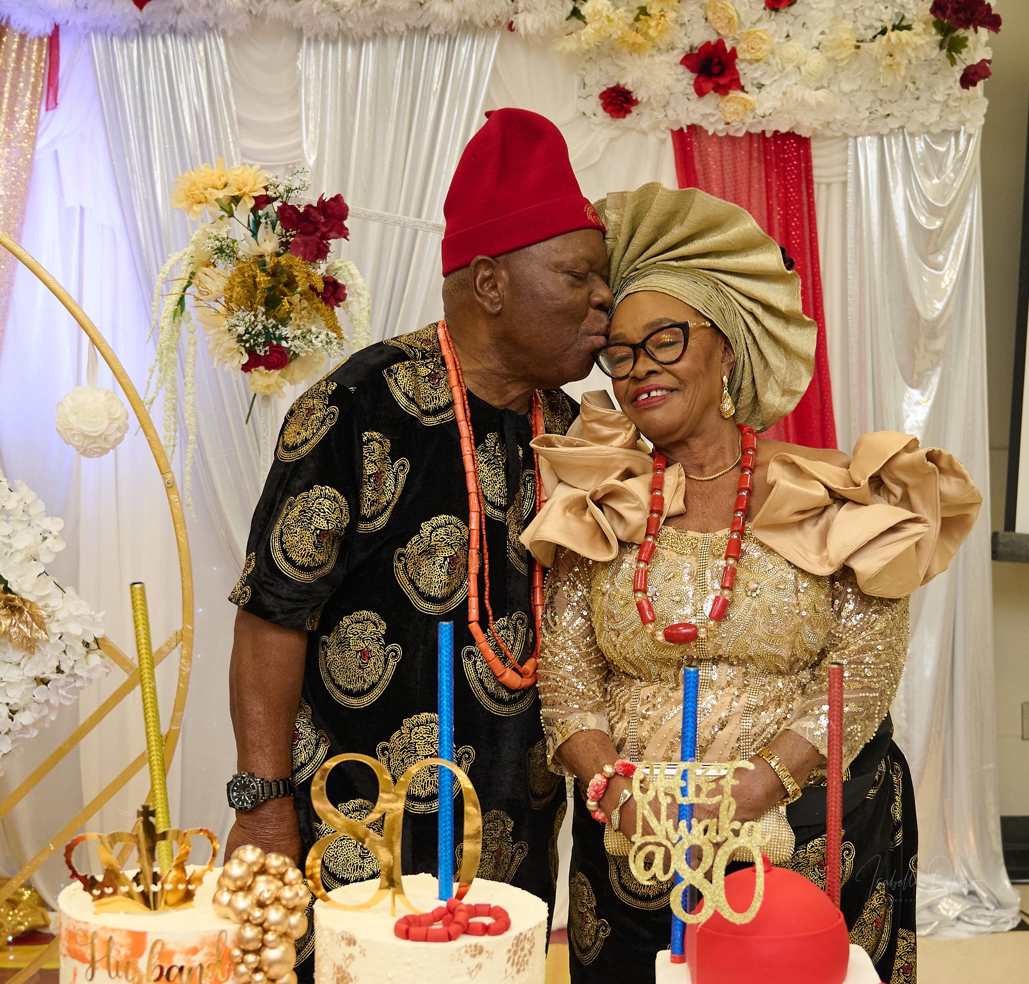 A celebratory moment at a traditional Nigerian wedding with a decorated cake.