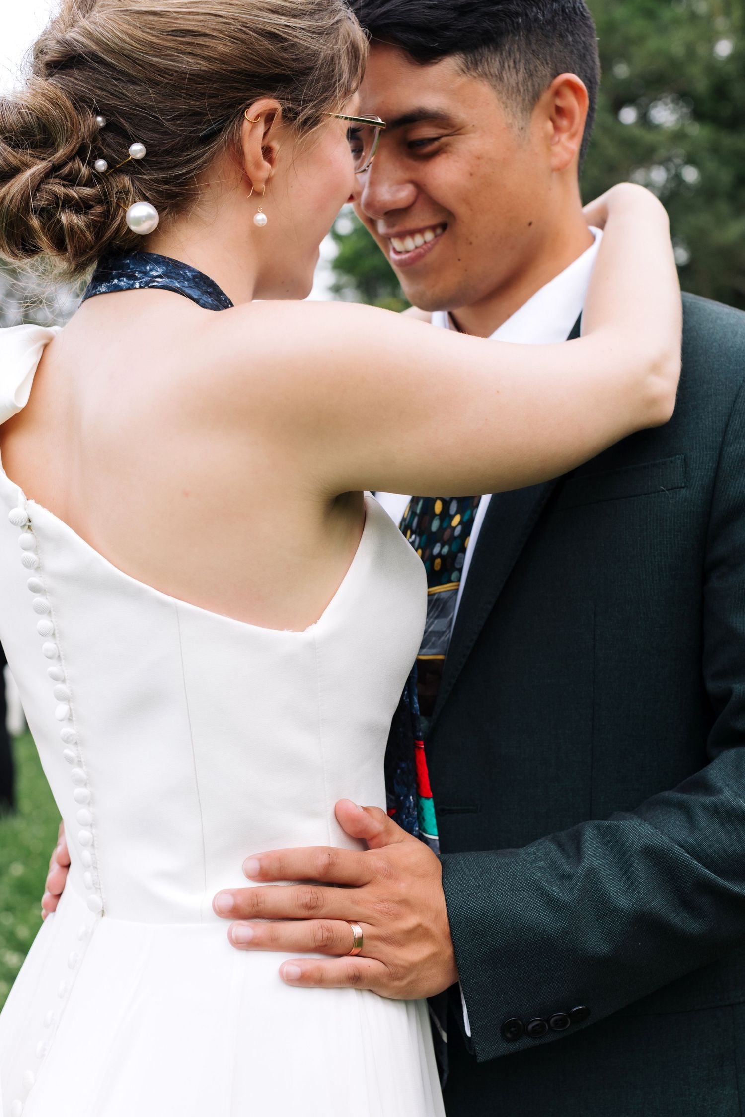 An intimate wedding moment captured with natural lighting in an outdoor setting.
