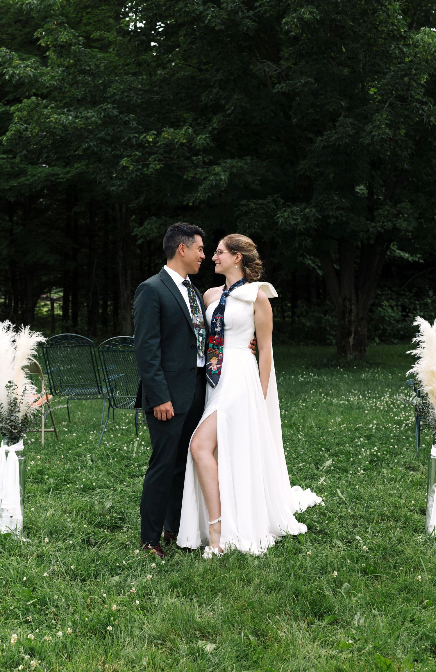 A romantic wedding portrait in a garden with white pampas grass decorations.