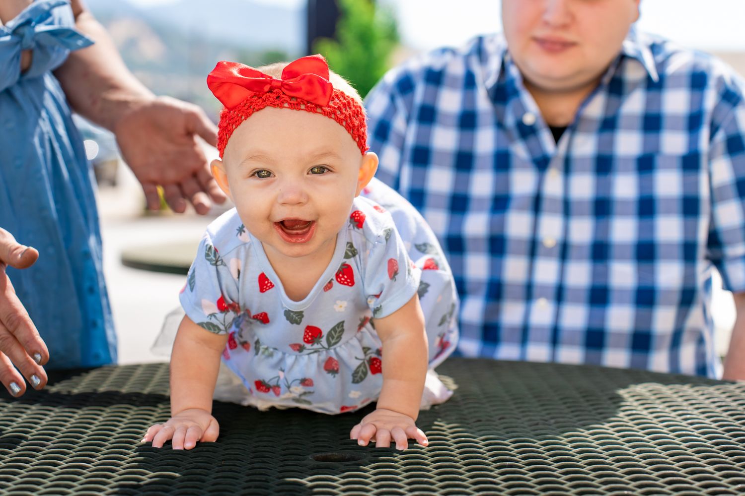 baby sister smiling and crawling on the table