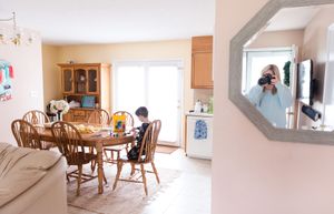 Interior view of a dining room with wooden furniture and a mirror reflection.