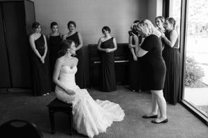 Wedding party scene with bridesmaids in black dresses.