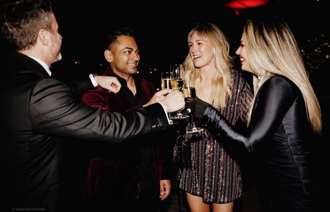 Group toasting drinks at a nighttime social gathering.