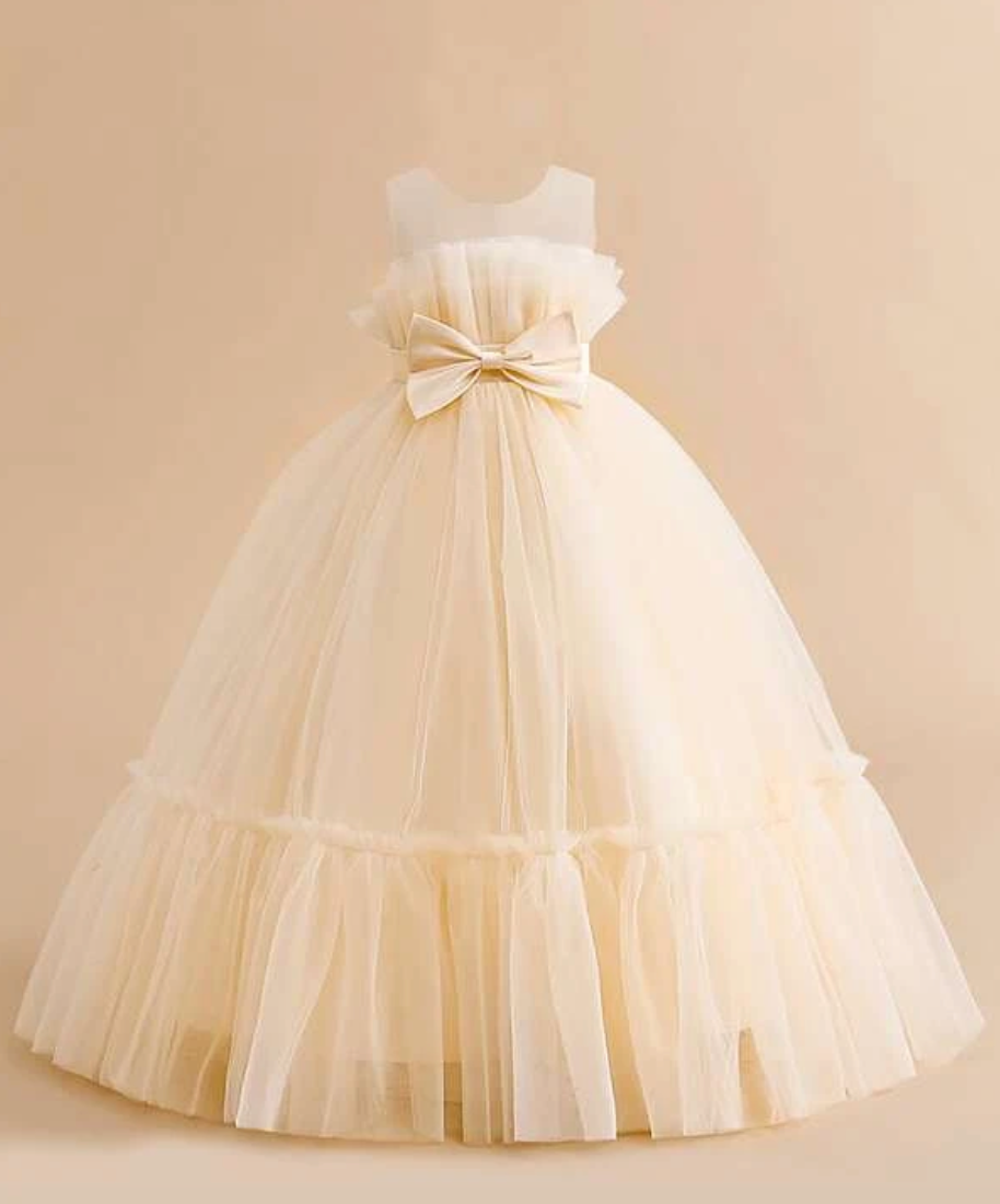 Ivory tulle princess gown with bow detail and tiered skirt design.