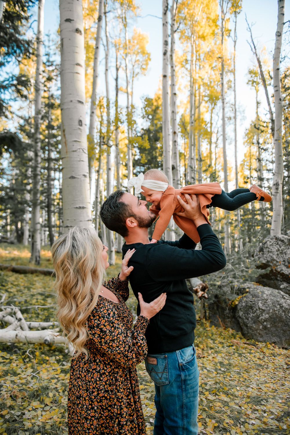 Playful family photo session in a beautiful aspen forest with fall colors.