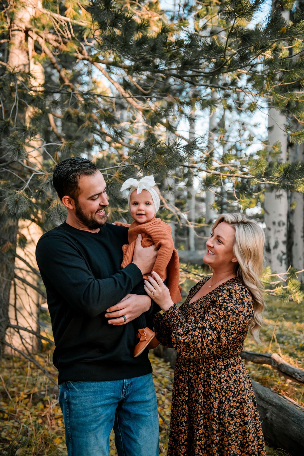 Candid family moments captured in a sunlit aspen grove during fall.