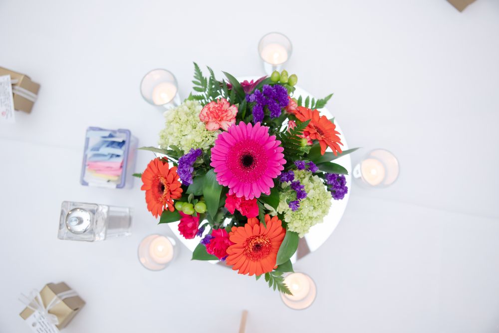 Overhead view of colorful wedding centerpiece with gerbera daisies and mixed flowers.
