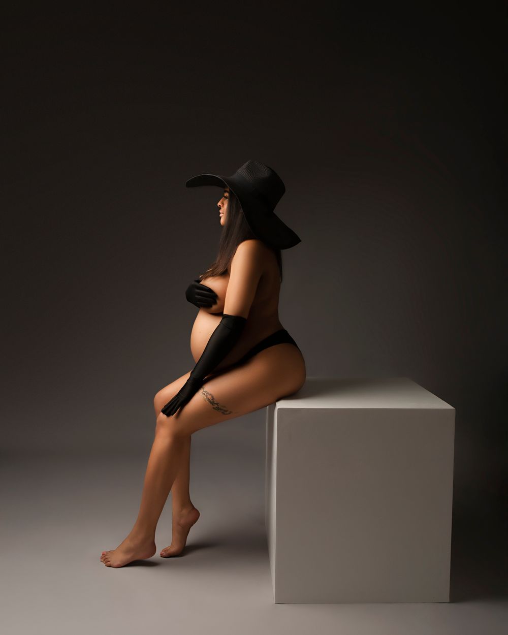 Maternity sexy mum to be in a hat portrait photo