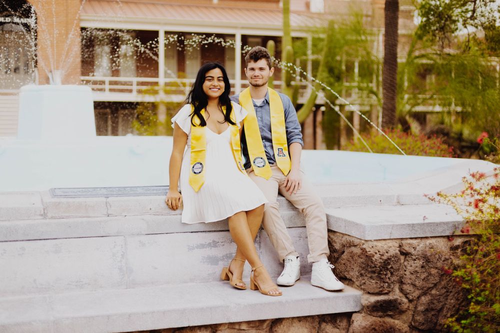 Celebratory graduation photos taken outdoors near brick university building.