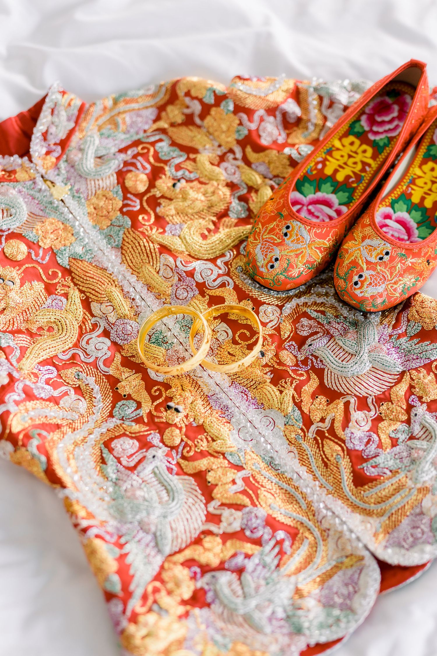 Traditional Chinese embroidered fabric with intricate red and gold dragon patterns.