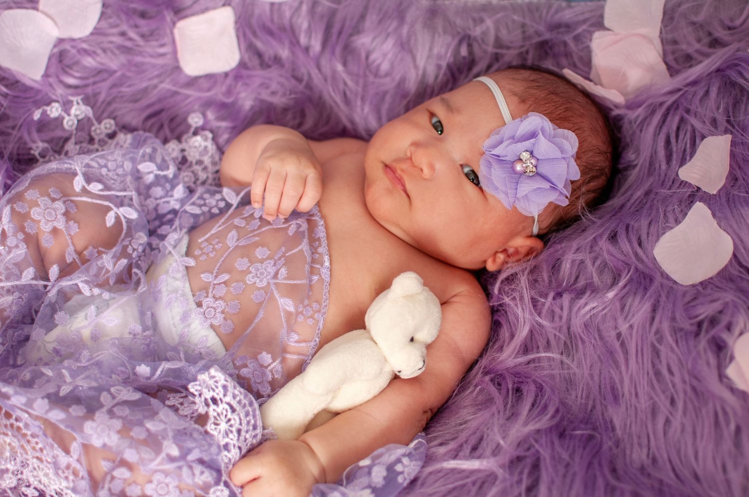 Newborn baby girl in purple