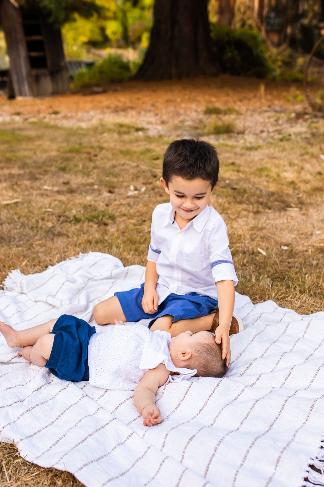 Brother playing with baby sister