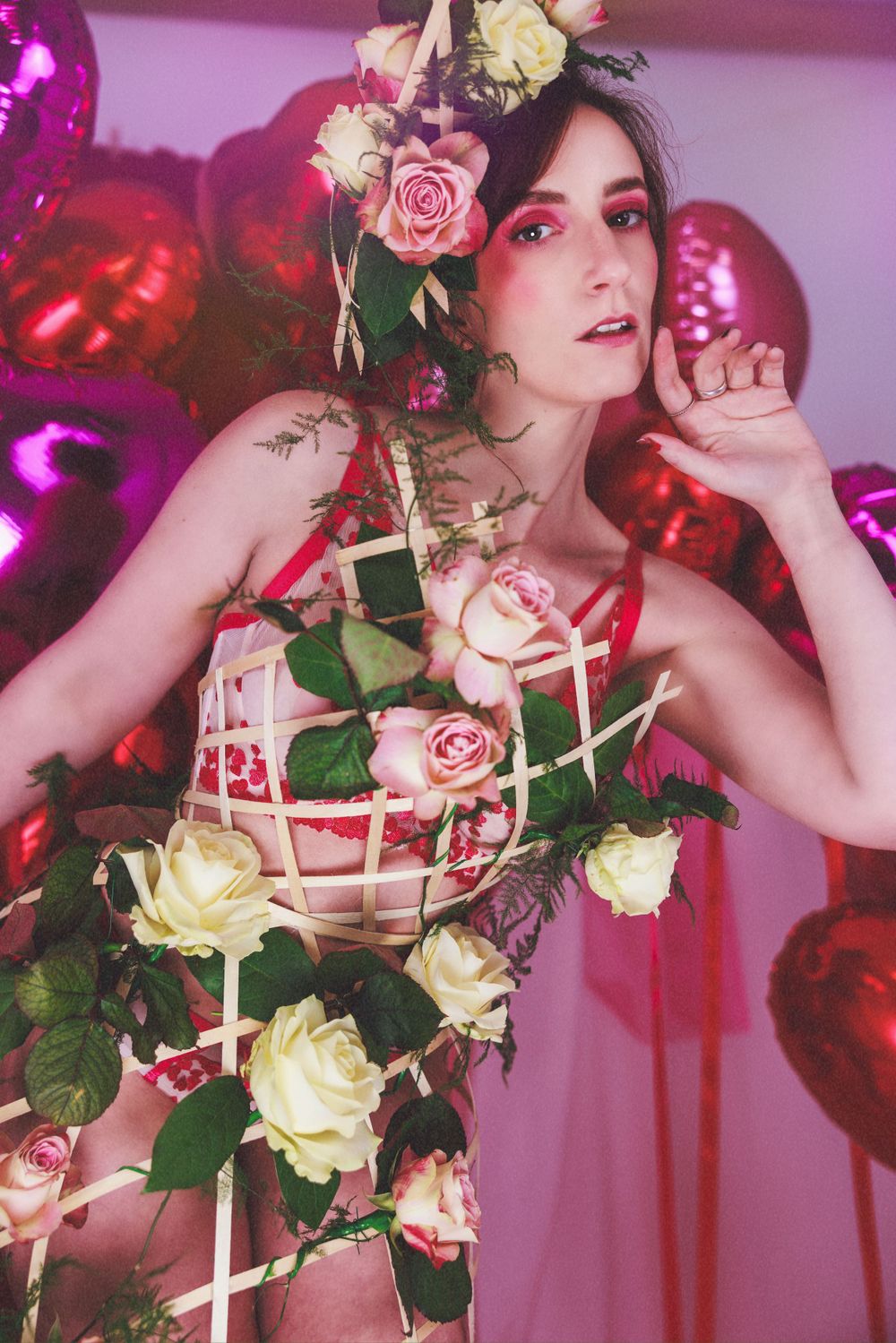 white model with floral headdress and cage dress posing for Valentine's themed shoot shot by Amy Davies in Hove studio