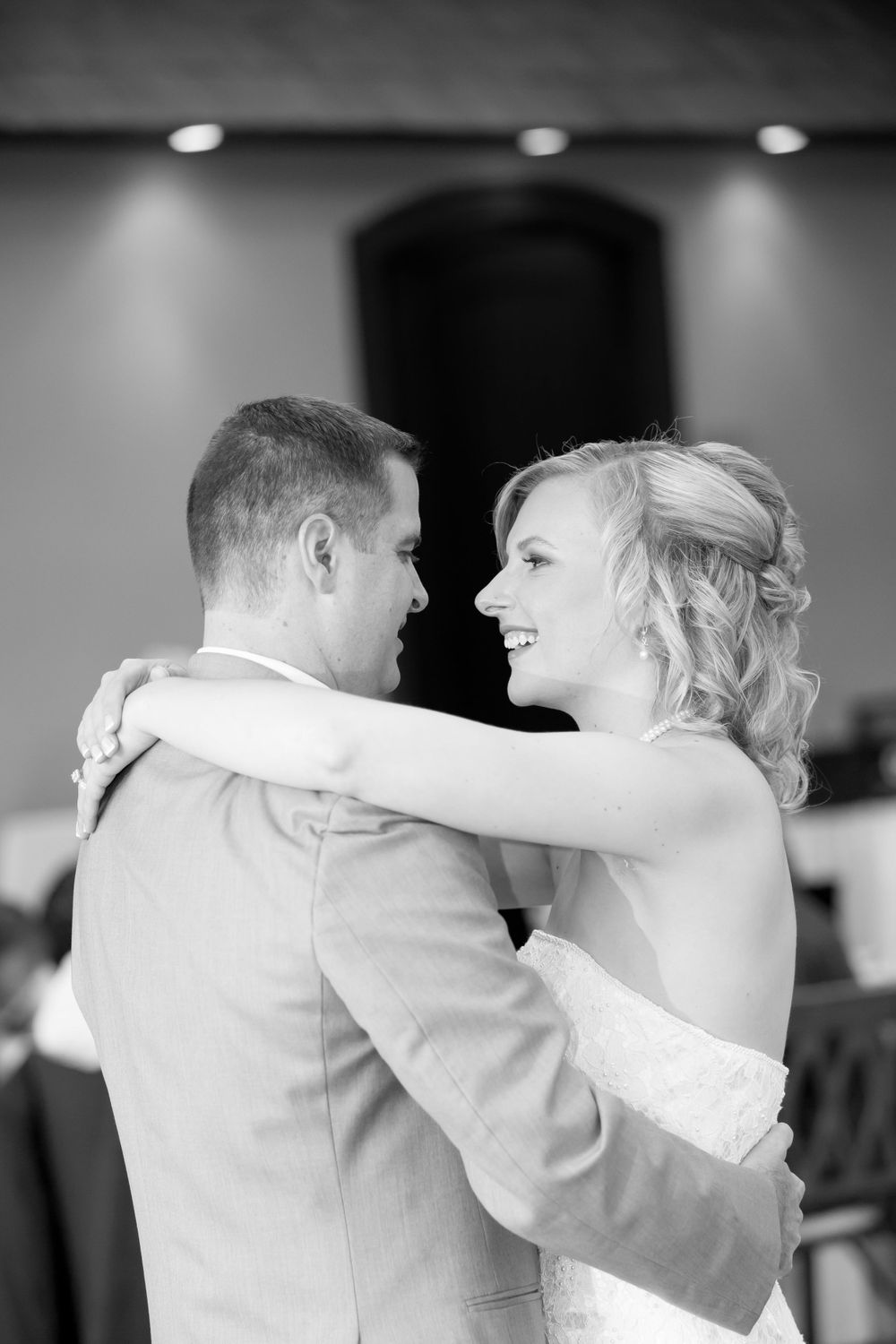A romantic black and white moment of a couple during their first dance.