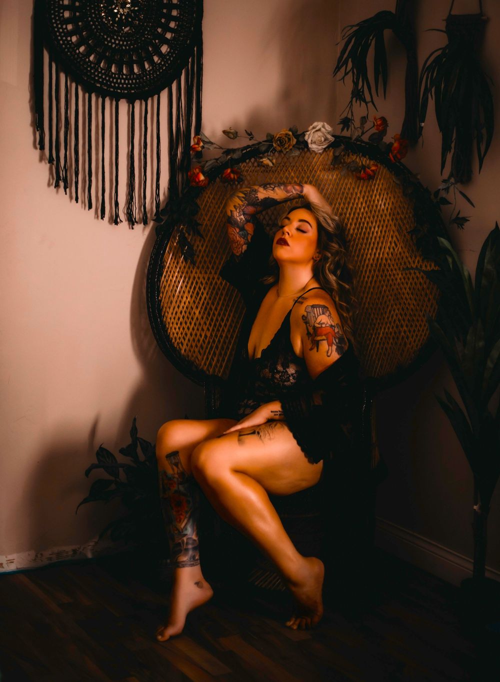 Vintage-inspired portrait with woven peacock chair and macrame wall hanging.