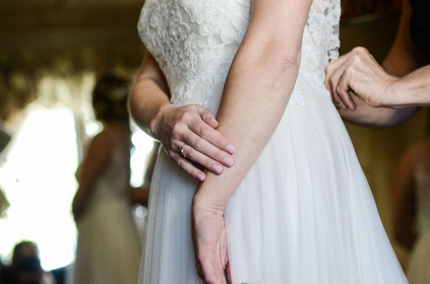 Close-up of wedding dress details showing delicate lace and fabric textures.