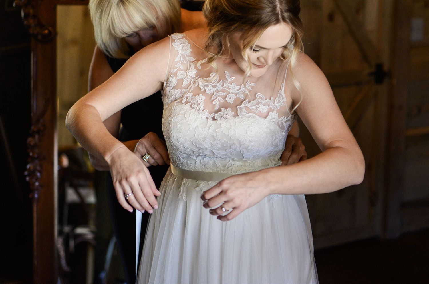 Close-up shots show details of a lace wedding dress and jewelry preparations.