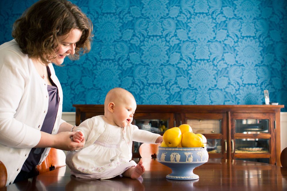 Mother and baby in kitchen with blue wallpaper, family portrait by Chris Rim Photo