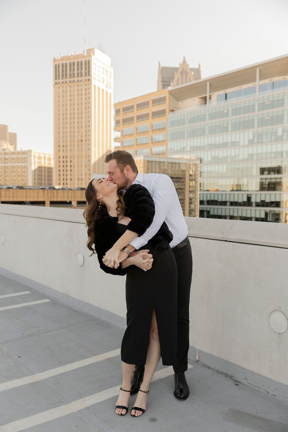 couple kissing on a rooftop in downtown Detroit