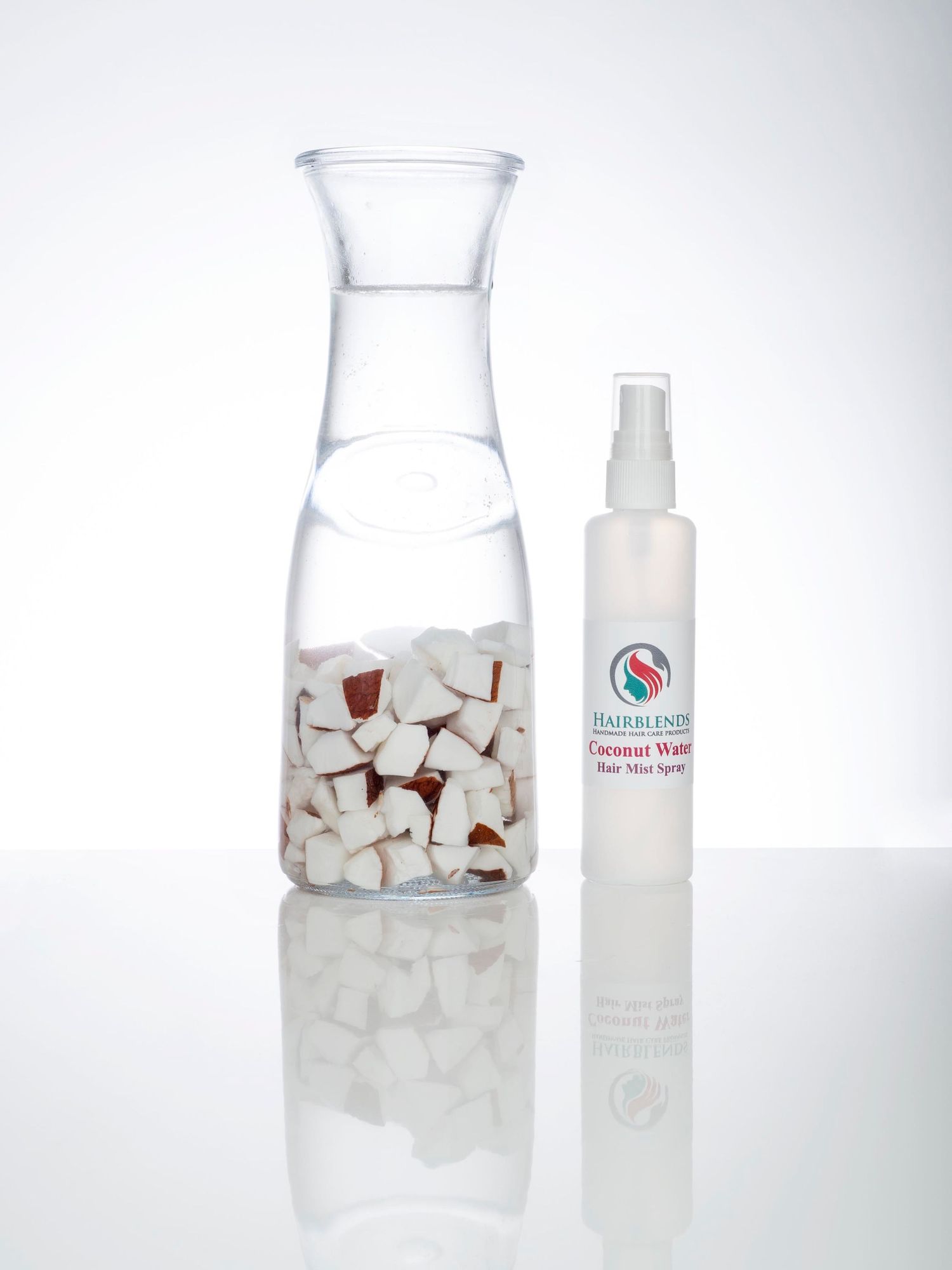A stylish bottle of water next to a glass jar brimming with coconuts, captured in a creative studio branding photo shoot by Abigail's Studio