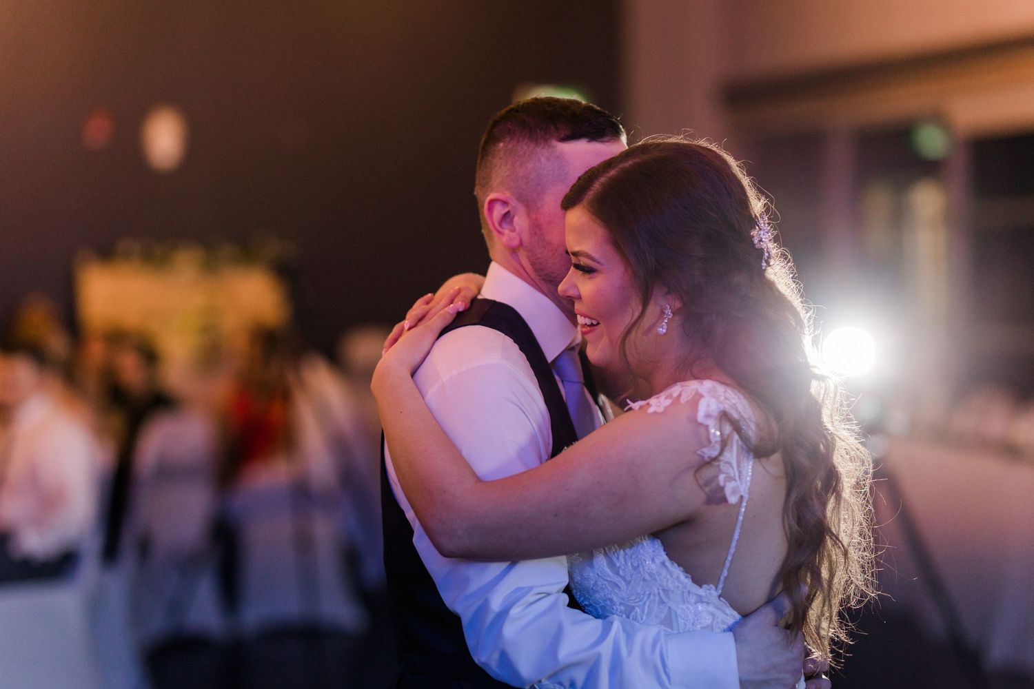 Wedding dance sequence captured in dim lighting with romantic atmosphere.