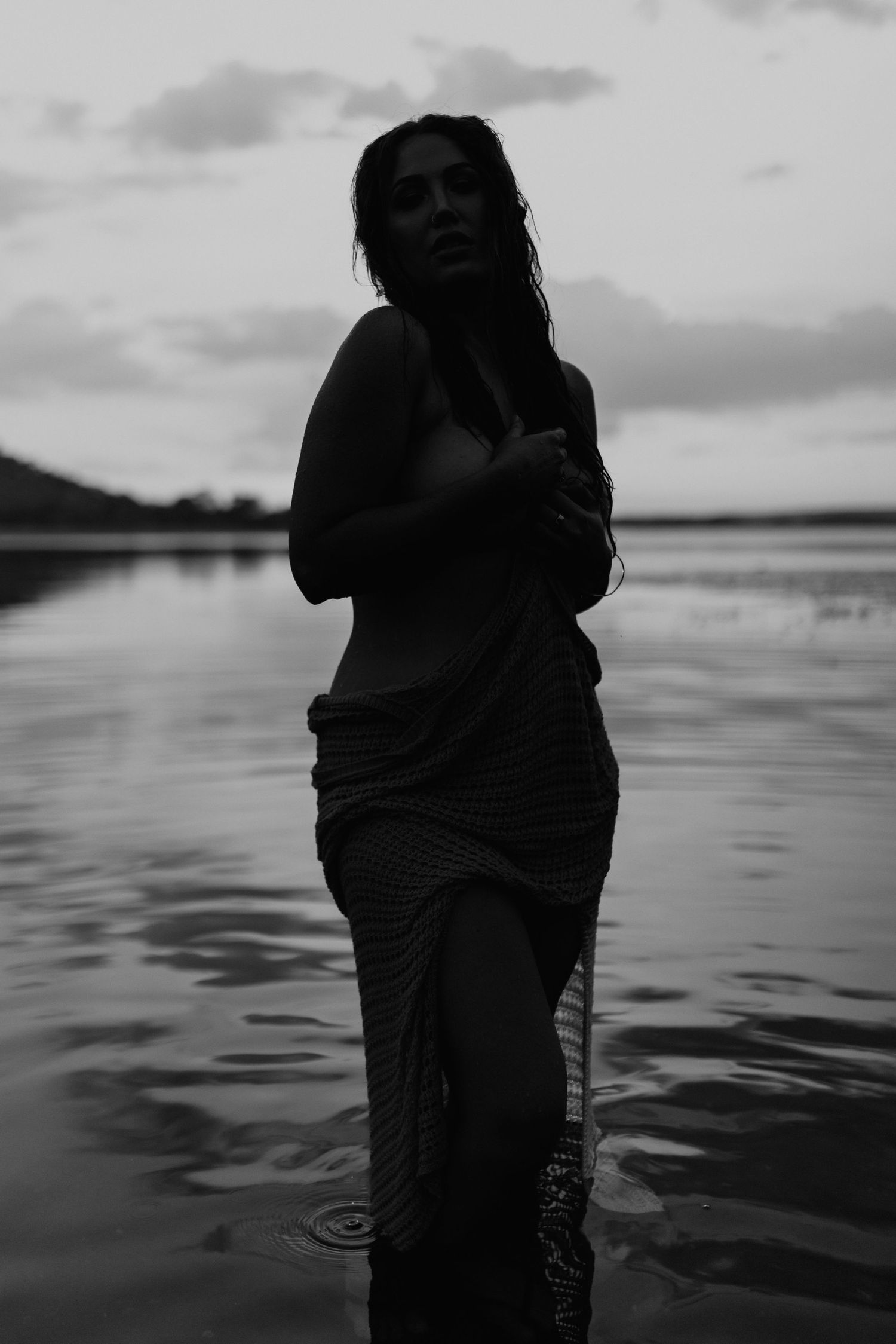 silhouette of woman standing in water at Lake Moondarra in Mount Isa