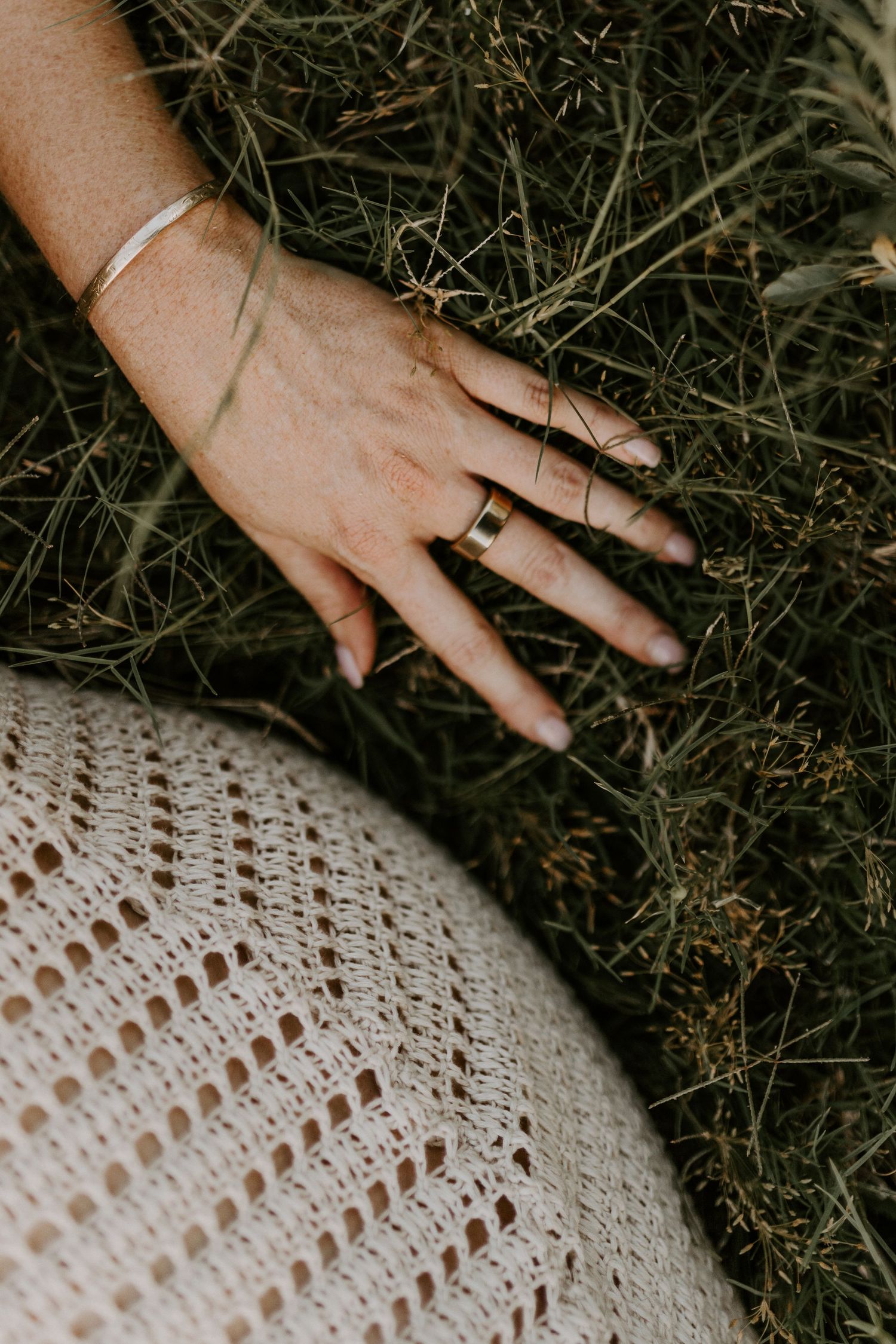 details of woman hand in the grass