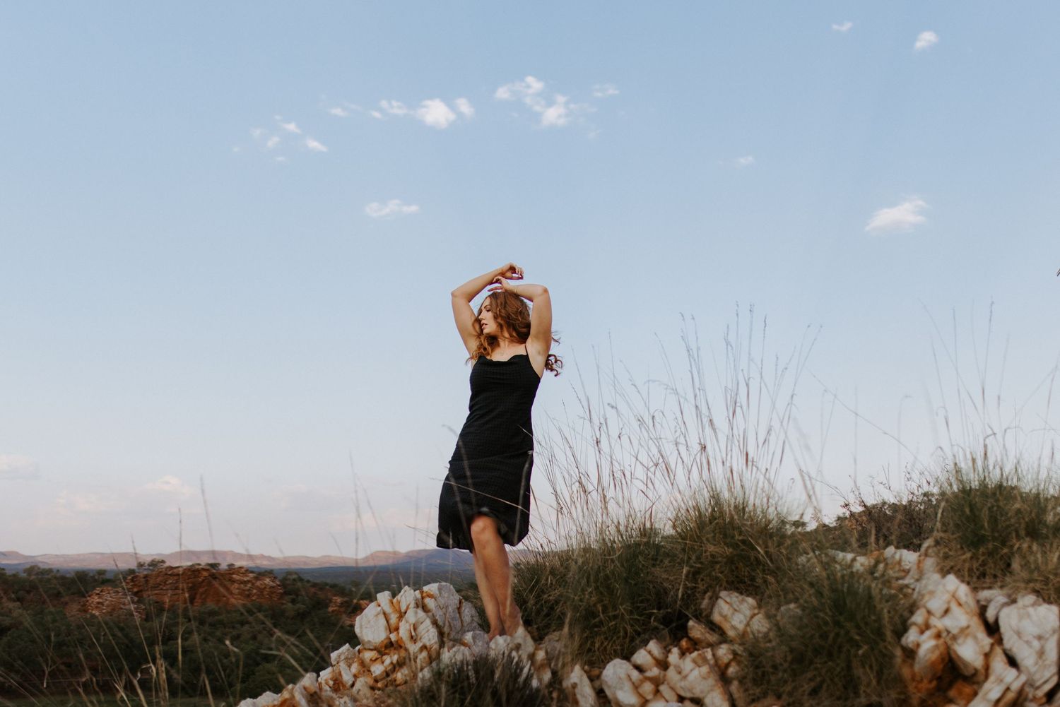 Woman caressing the wind at Lake Moondarra, Mount Isa