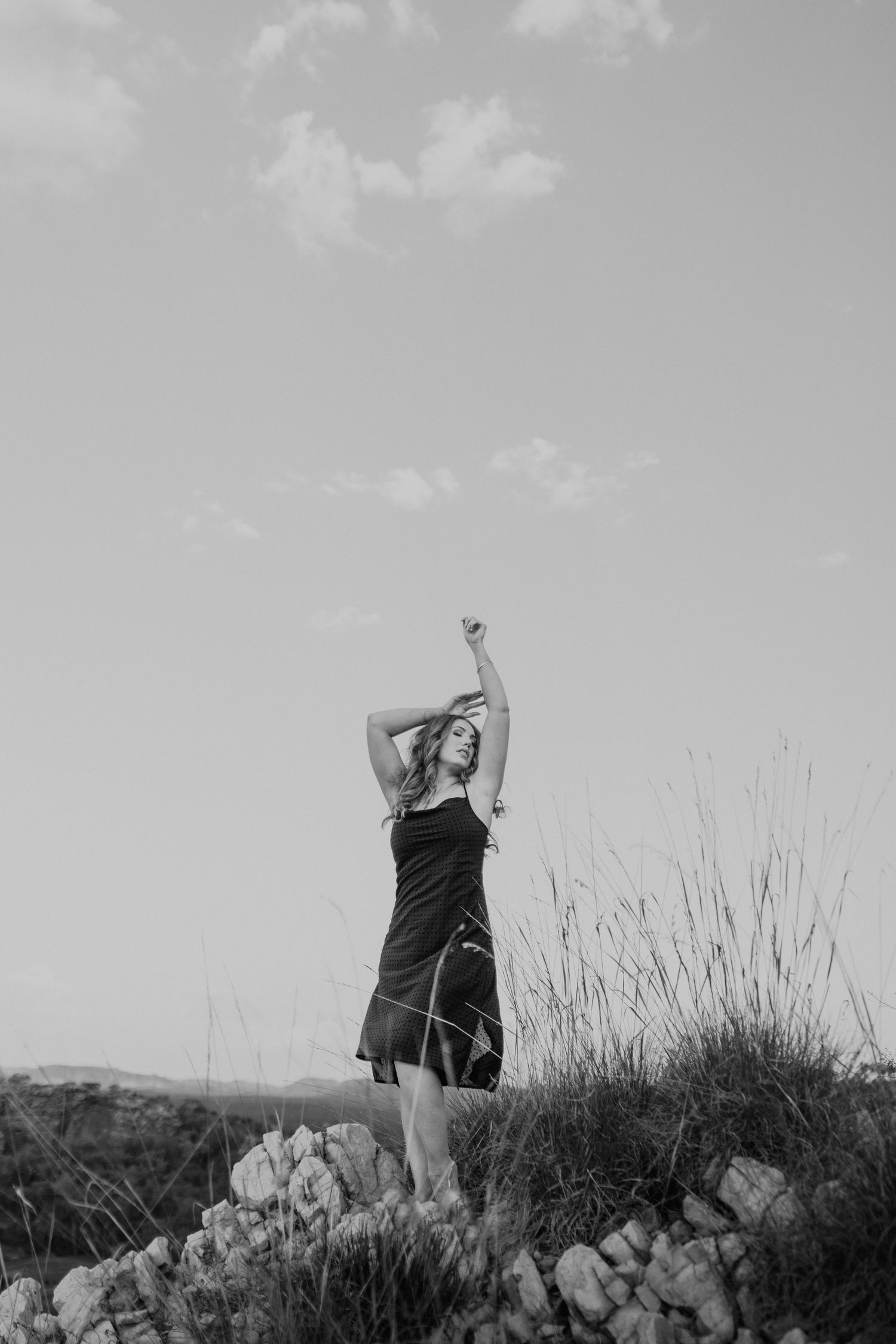 Woman caressing the wind at Lake Moondarra, Mount Isa