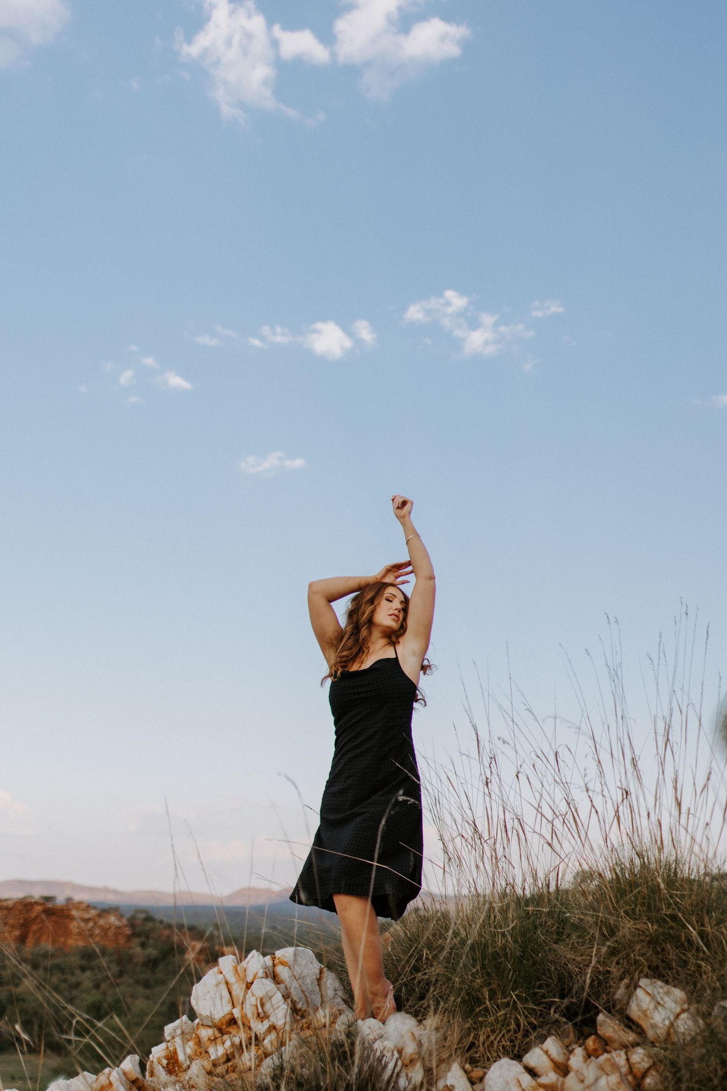Woman caressing the wind at Lake Moondarra, Mount Isa
