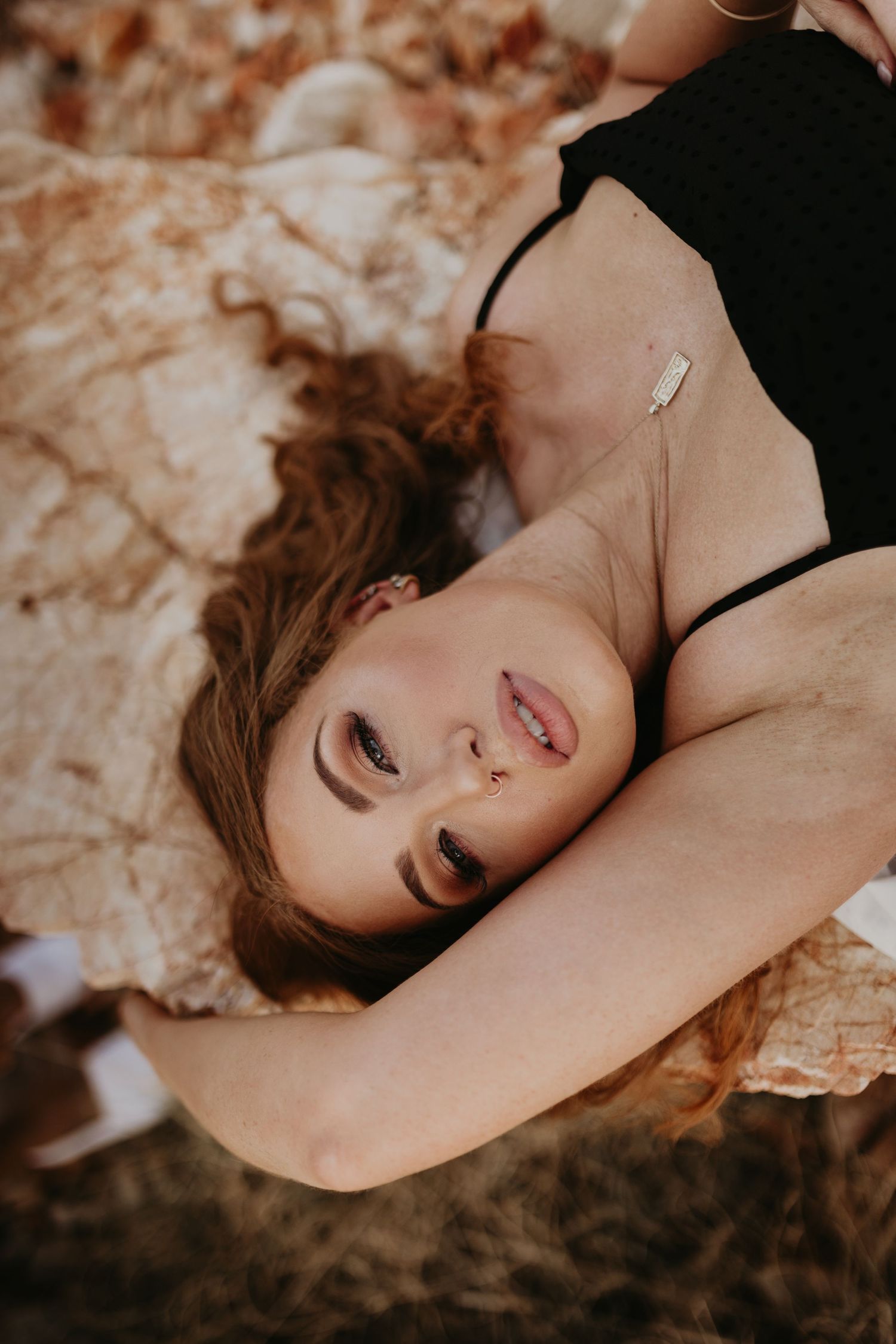 Woman laying down with arm above her head at Lake Moondarra, Mount Isa