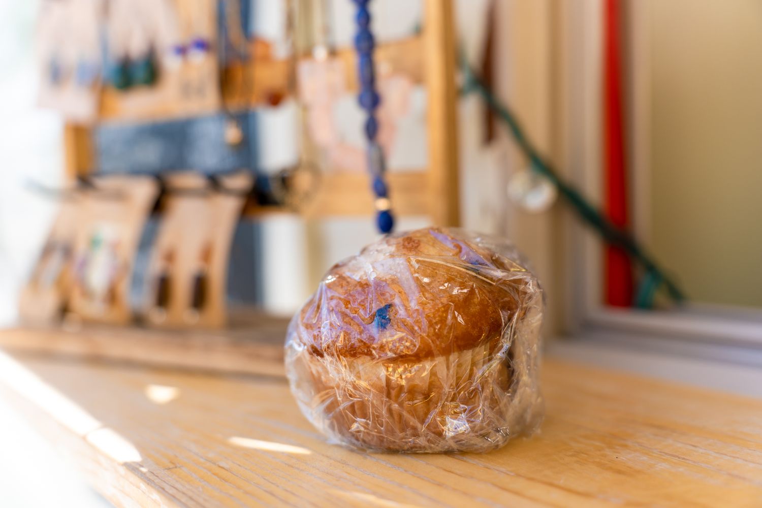 Muffin for sale with mushroom earrings in the background