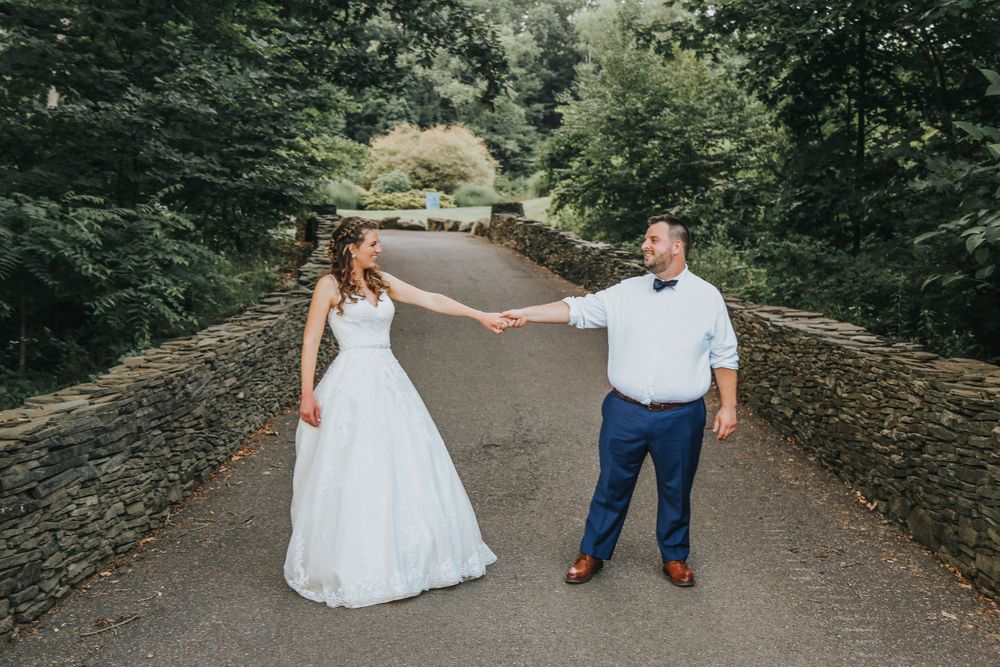 summer wedding picture of bride and groom on bridge in binghamton, ny