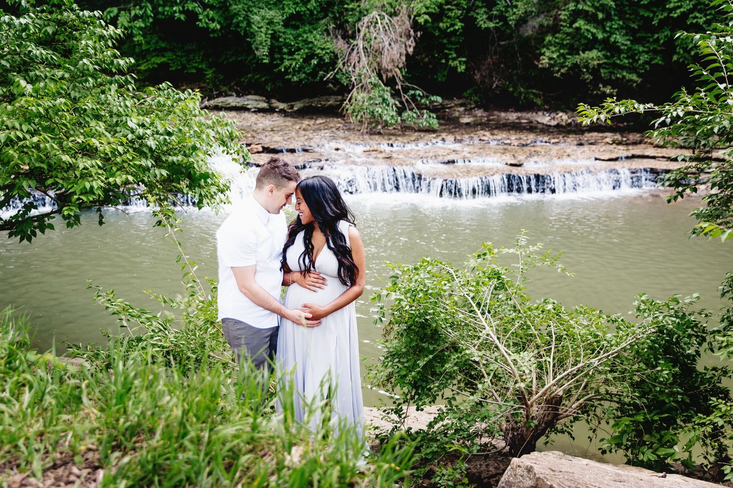 pregnant woman and man standing near river in lee's summit Missouri