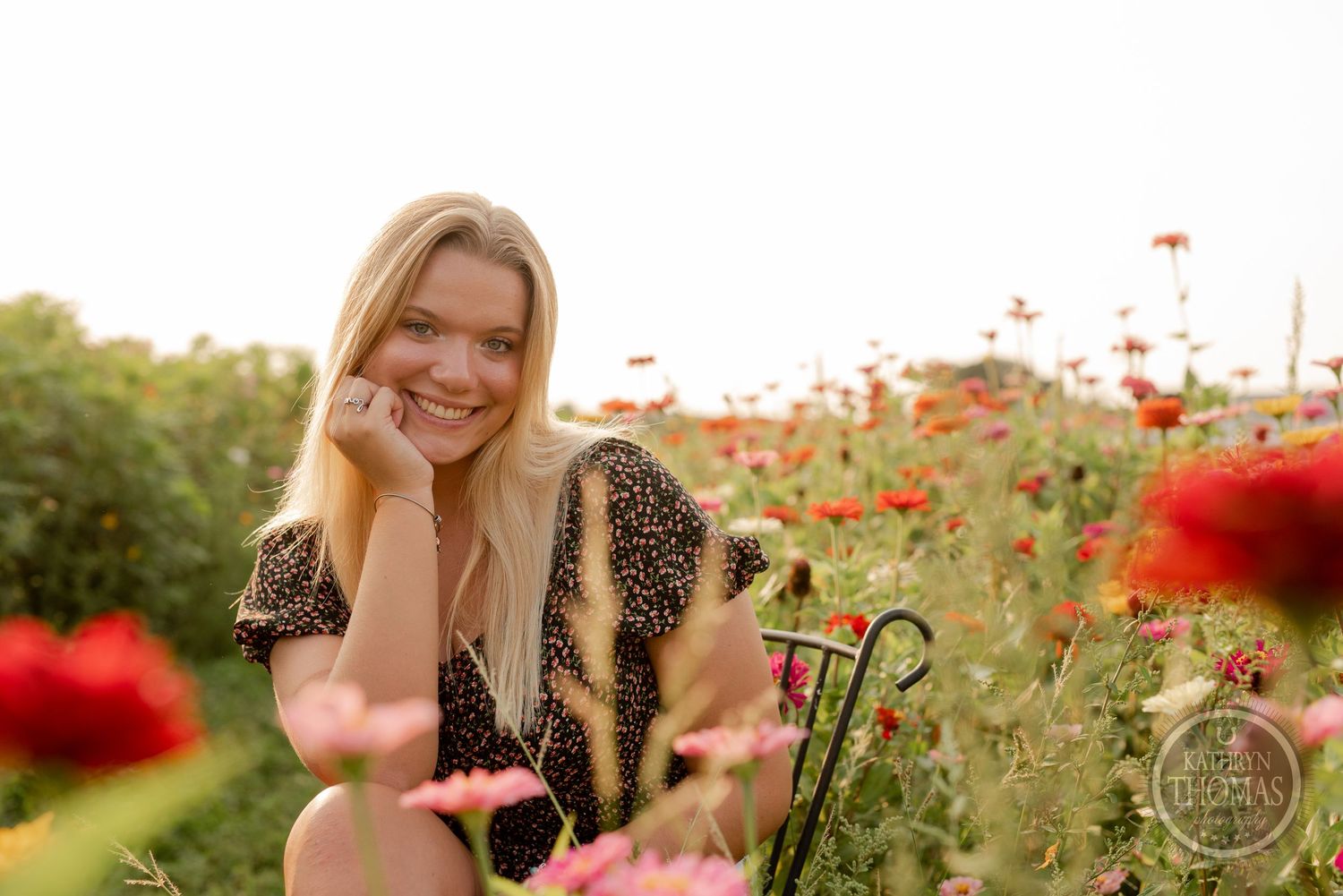 Candid sunset portrait amidst vibrant red poppies and greenery.