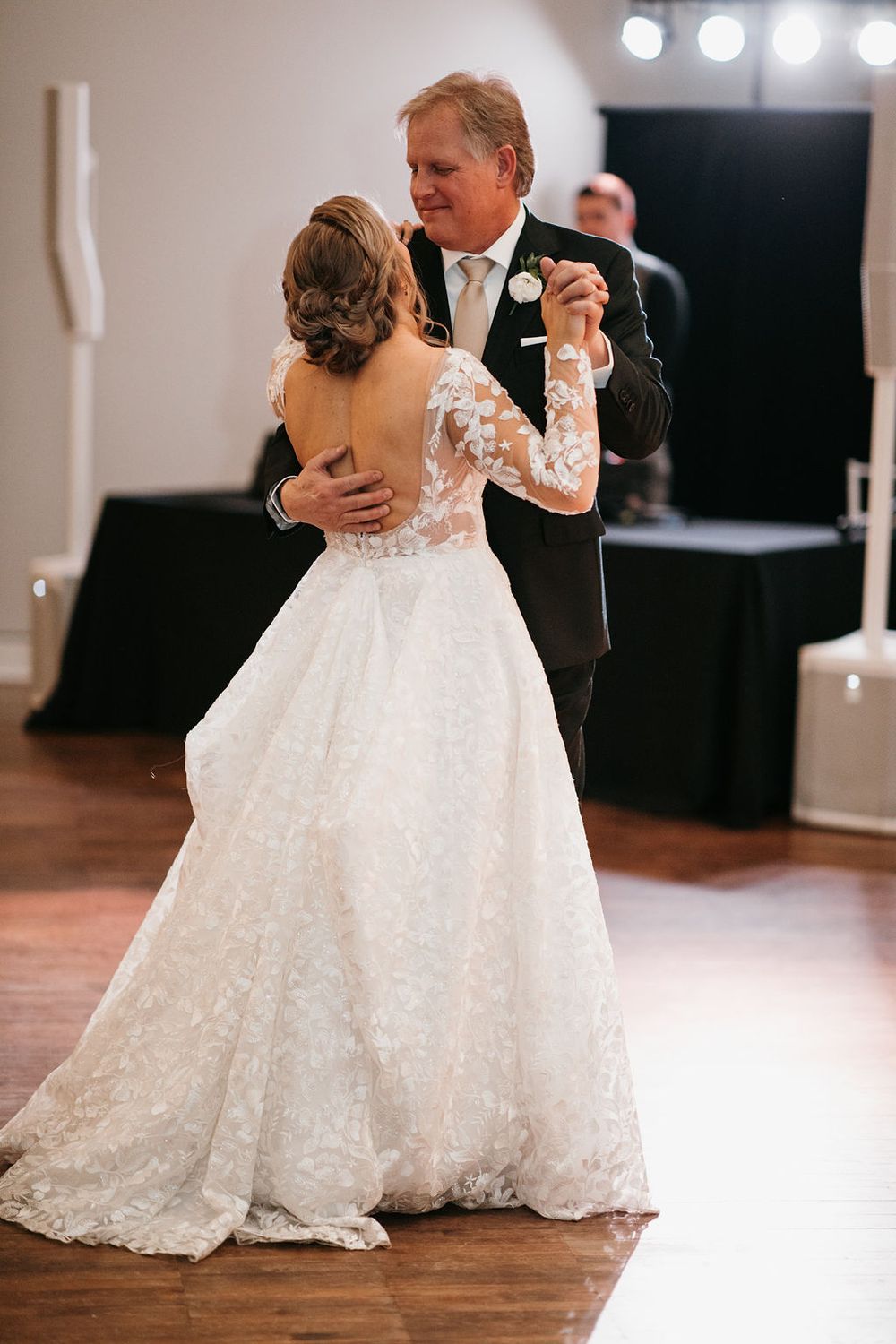 Father and bride share a beautiful father-daughter dance at elegant wedding reception.