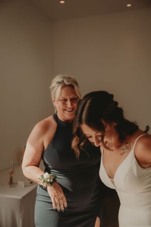 A joyful candid moment captured during wedding day preparations.