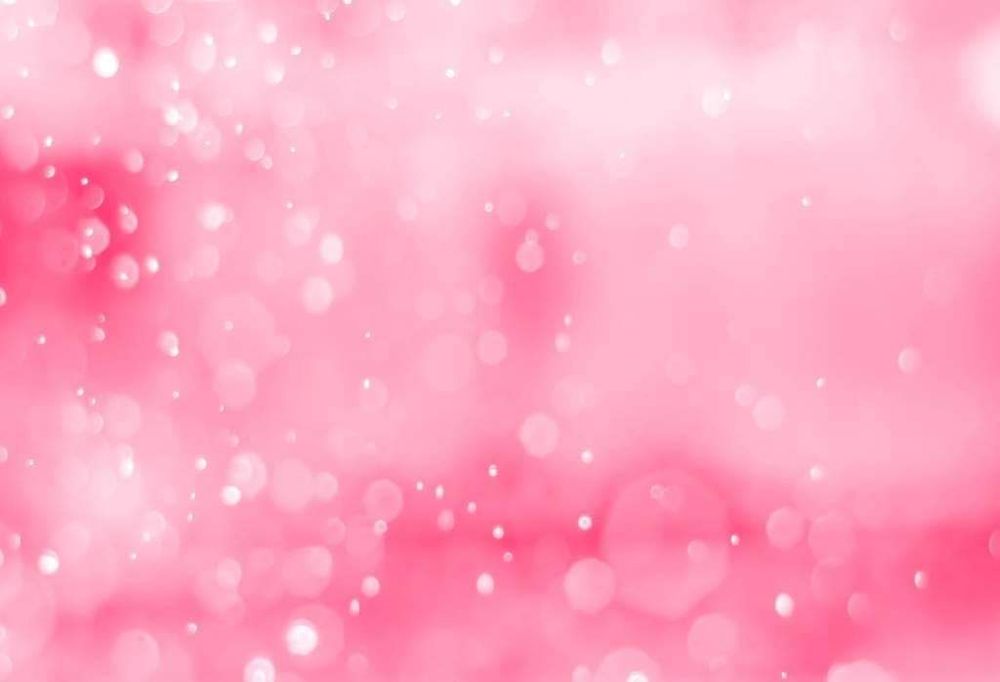 Abstract pink bokeh background with soft glowing lights and sparkles.