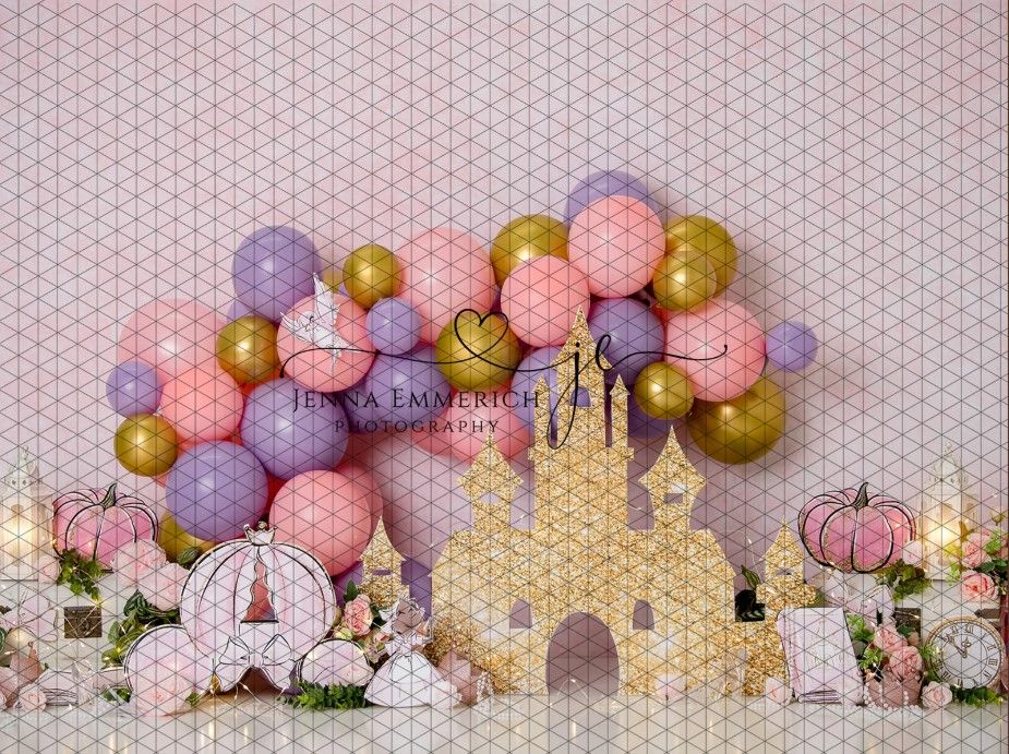 Magical princess themed party backdrop with gold castle cutout and pink and purple balloon arch decorations.