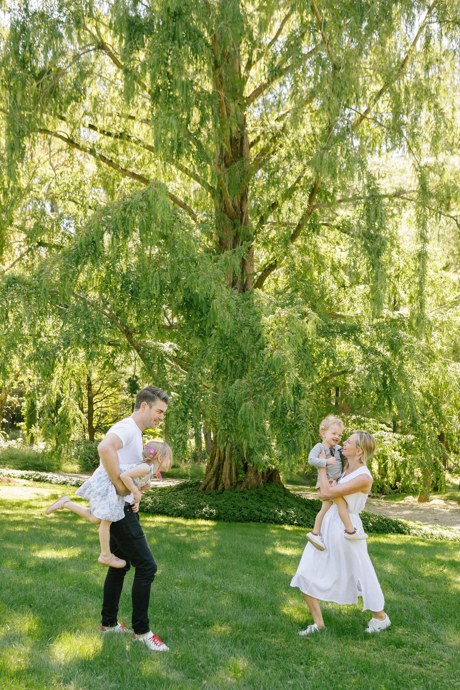 Candid of family at backyard during family session, photographed by Paula Brearley NYC family photographer