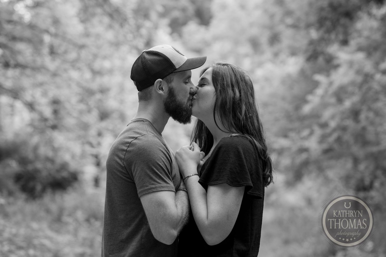 A black and white photo capturing an intimate moment between a couple.