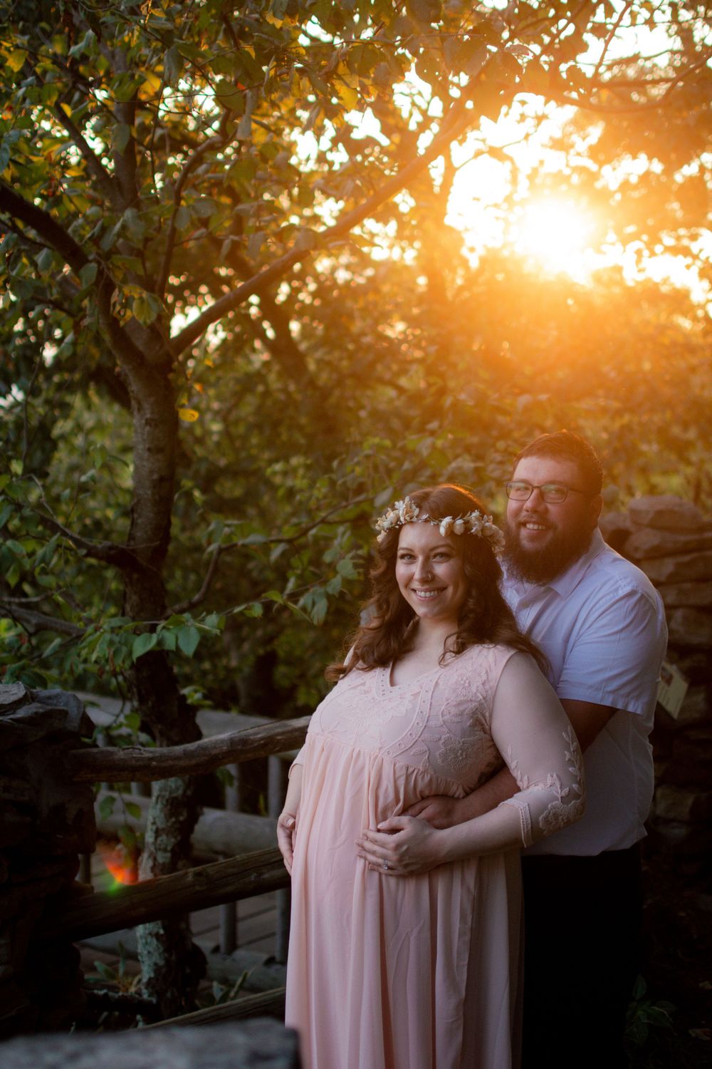 Golden sunset light filters through trees during an intimate outdoor portrait session.